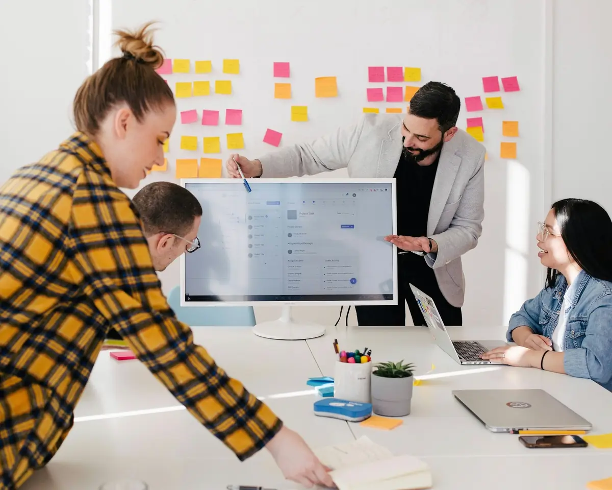 Marketing team planning a digital campaign around a strategy board